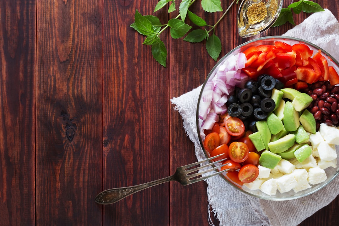 Bowl of vegetable salad with avocado and cheese
